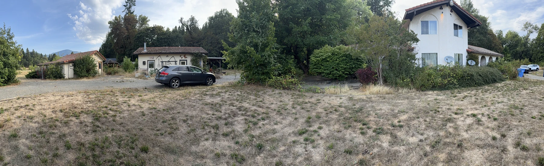 The house and outbuildings before rehab, photographed in September 2025
